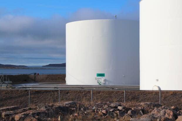 A tank farm outside Kugaaruk, Nunavut in September. MLAs delayed a pair of bills to increase Nunavut's spending on fuel over cost estimates they said were not justified. (John Last/CBC - image credit)