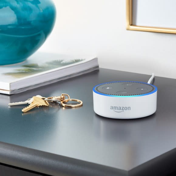 White Amazon Echo Dot on a table next to house keys.