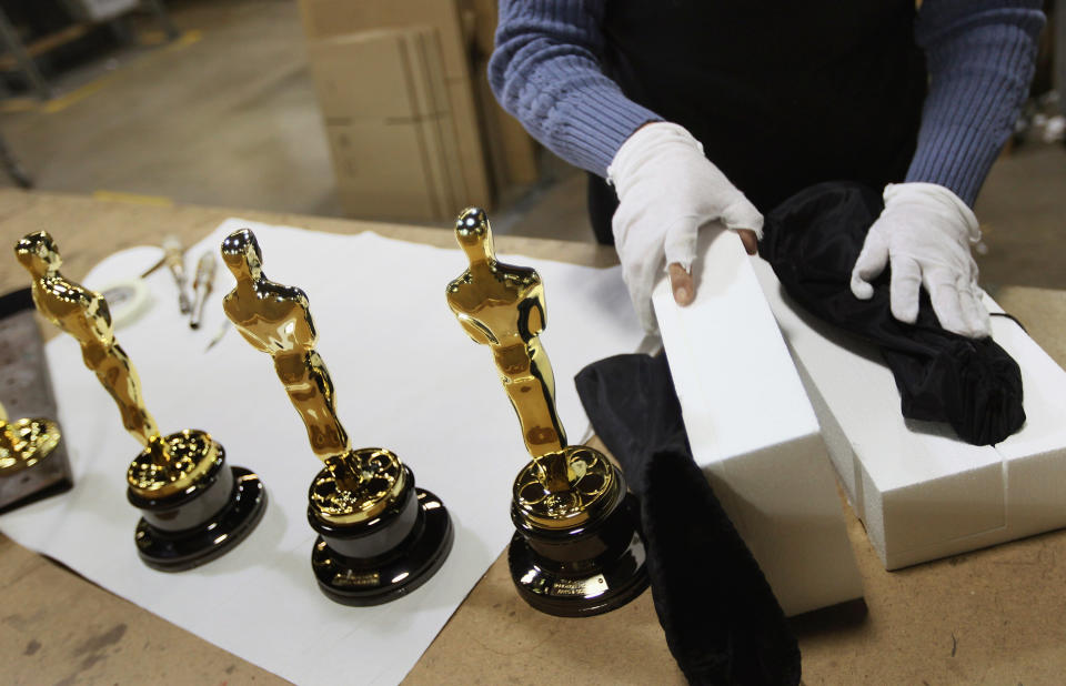 CHICAGO, IL - FEBRUARY 09: Josefina Govea packages an Oscar statuette at R.S. Owens & Company February 9, 2012 in Chicago, Illinois. R.S. Owens manufactures the Oscar statuettes which are presented at the annual Academy Awards by the Academy of Motion Picture Arts and Sciences. After the theft of the statuettes prior to the 2000 Academy Awards the company began casting the statuettes one year in advance of the show. (Photo by Scott Olson/Getty Images)