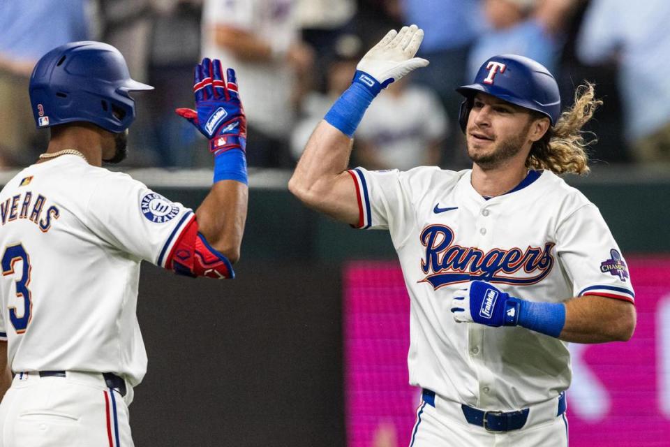 Texas Rangers outfielder Travis Jankowski (16) celebrates with his teammate Leody Taveras (3) after hitting the game tying home run in the ninth inning of their season opener against the Chicago Cubs at Globe Life Field in Arlington on Thursday, March 28, 2024. Chris Torres/ctorres@star-telegram.com