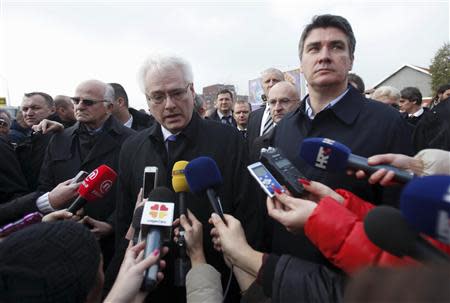 Croatian President Ivo Josipovic (C) talks to the media with Prime Minister Zoran Milanovic (R) during a ceremony to mark the 22th anniversary of Vukovar's fall, in downtown Vukovar November 18, 2013. REUTERS/Antonio Bronic