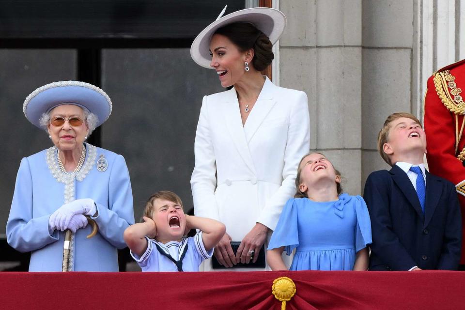 Prince Louis of Cambridge (2L) holds his ears as he stands next to Britain's Queen Elizabeth II (L), his m mother Britain's Catherine, Duchess of Cambridge (C), Britain's Princess Charlotte of Cambridge (2R)and Britain's Prince George of Cambridge to watch a special flypast from Buckingham Palace balcony following the Queen's Birthday Parade, the Trooping the Colour