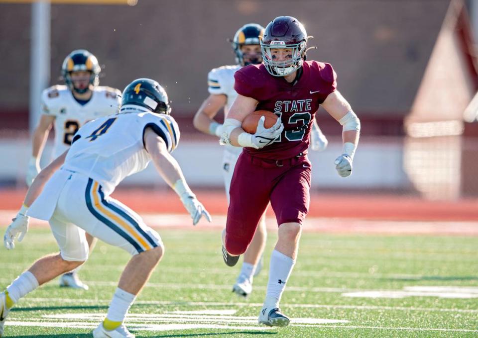 Mt. Lebanon defenders try to stop State College’s Brady Bendik as he runs down the field with the ball during the PIAA class 6A semifinal game on Saturday, Dec. 4, 2021 at Mansion Park. Mt. Lebanon won, 49-28.