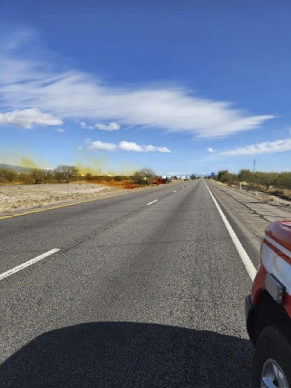 This image provided by the Arizona Department of Public Safety shows what the department says was an accident involving a commercial tanker truck that caused a hazardous material to leak onto Interstate 10 outside Tucson, Ariz., on Tuesday, Feb. 14, 2023, prompting state troopers to shut down traffic on the freeway. (Arizona Department of Public Safety via AP)