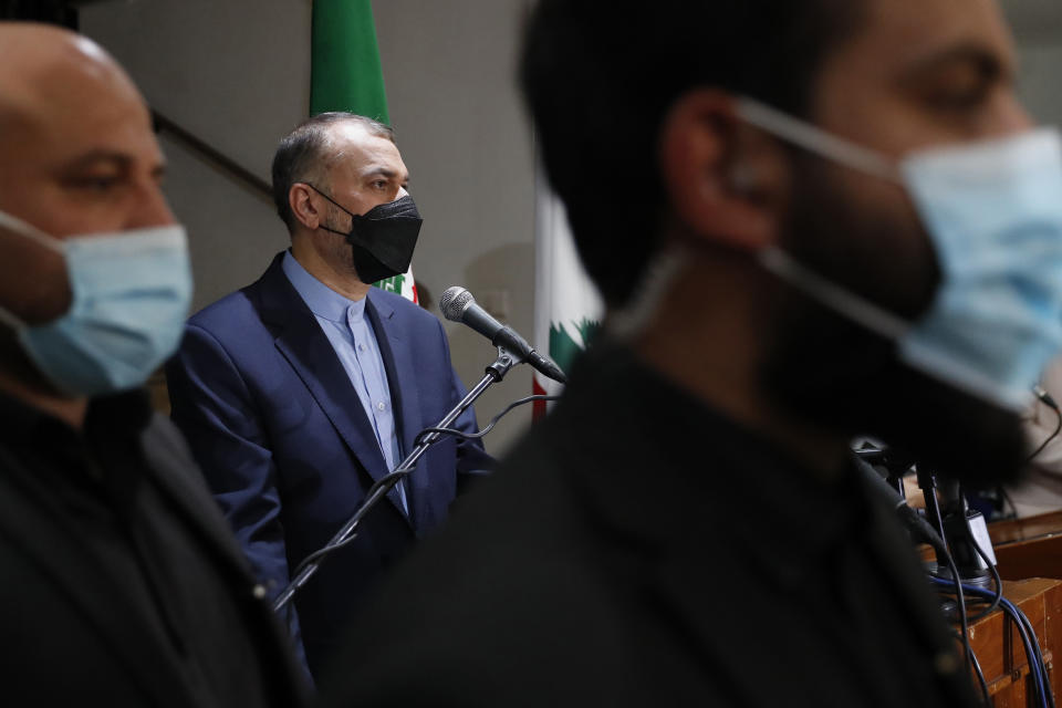 Iranian Foreign Minister Hossein Amirabdollahian, center, is flanked by bodyguards as he speaks during a joint press conference with his Lebanese counterpart Abdullah Bou Habib in Beirut, Lebanon, Thursday, Oct. 7, 2021. Amirabdollahian said he discussed with officials in Beirut the "positive" effects of ongoing talks between Iran and Saudi Arabia, and blamed foreign troops based in the Middle East for regional instability. (AP Photo/Hussein Malla)