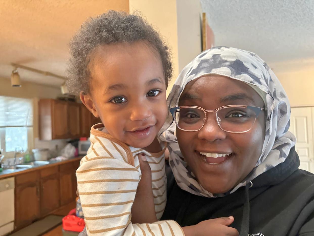 Hagir Sail plays with her 19-month-old son Sufyan Ahmed in the kitchen of her northeast Calgary home.  (Elise Stolte/CBC - image credit)