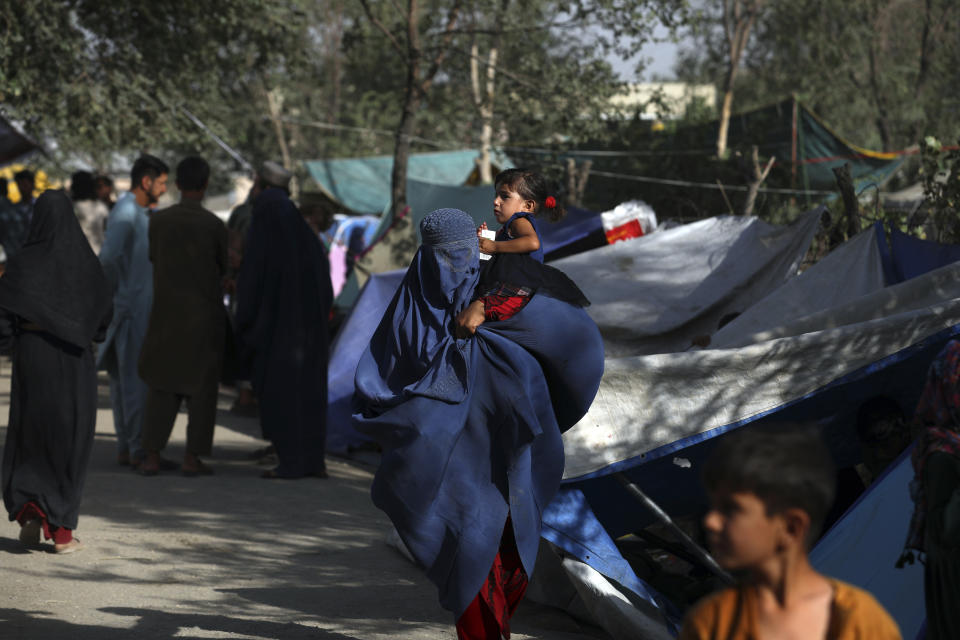 Internally displaced Afghans from northern provinces, who fled their home due to fighting between the Taliban and Afghan security personnel, take refuge in a public park Kabul, Afghanistan, Friday, Aug. 13, 2021. The Taliban have completed their sweep of the country's south on Friday, as they took four more provincial capitals in a lightning offensive that is gradually encircling Kabul, just weeks before the U.S. is set to officially end its two-decade war. (AP Photo/Rahmat Gul)