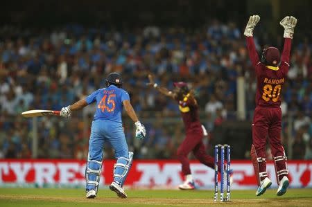 Cricket - West Indies v India - World Twenty20 cricket tournament semi-final - Mumbai, India - 31/03/2016. West Indies wicketkeeper Denesh Ramdin (R) appeals successfully for the wicket of India's Rohit Sharma. REUTERS/Danish Siddiqui -