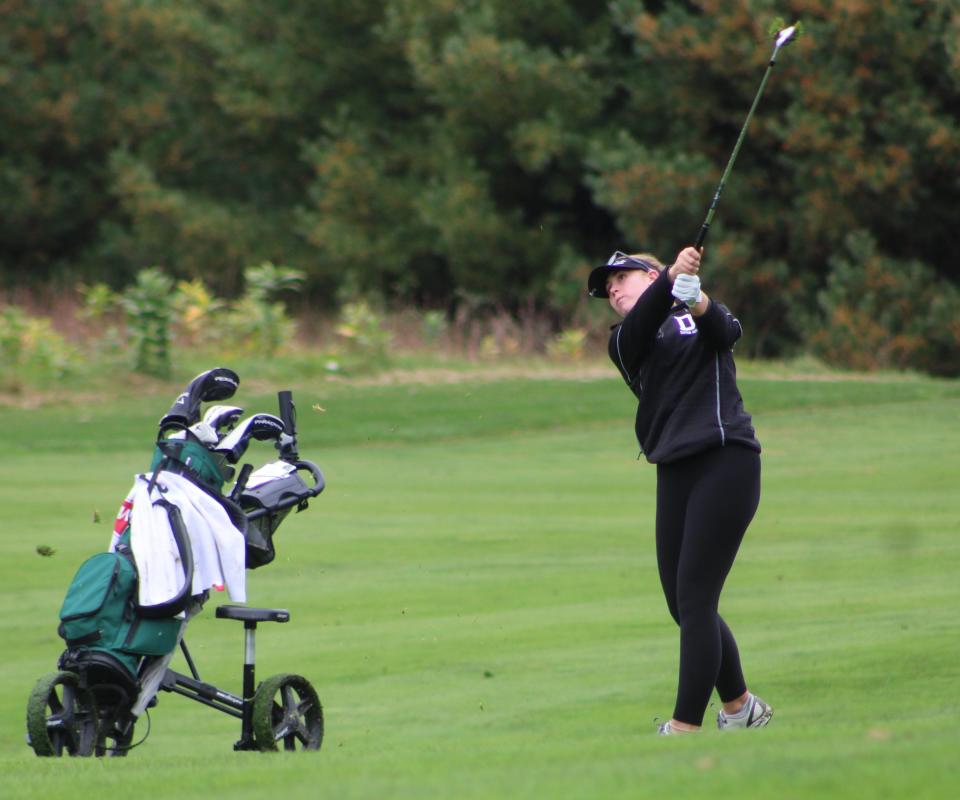 Dover's Carys Fennessy follows through with an approach shot during Tuesday's Division I tournament at Canterbury Woods Country Club.