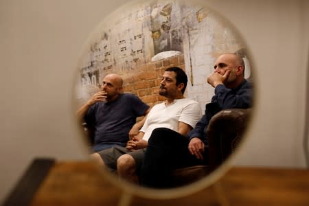 Co-creators of HBO series "Our Boys", Hagai Levi, Tawfik Abu Wael, and Joseph Cedar, pose for a picture during their interview with Reuters in Tel Aviv