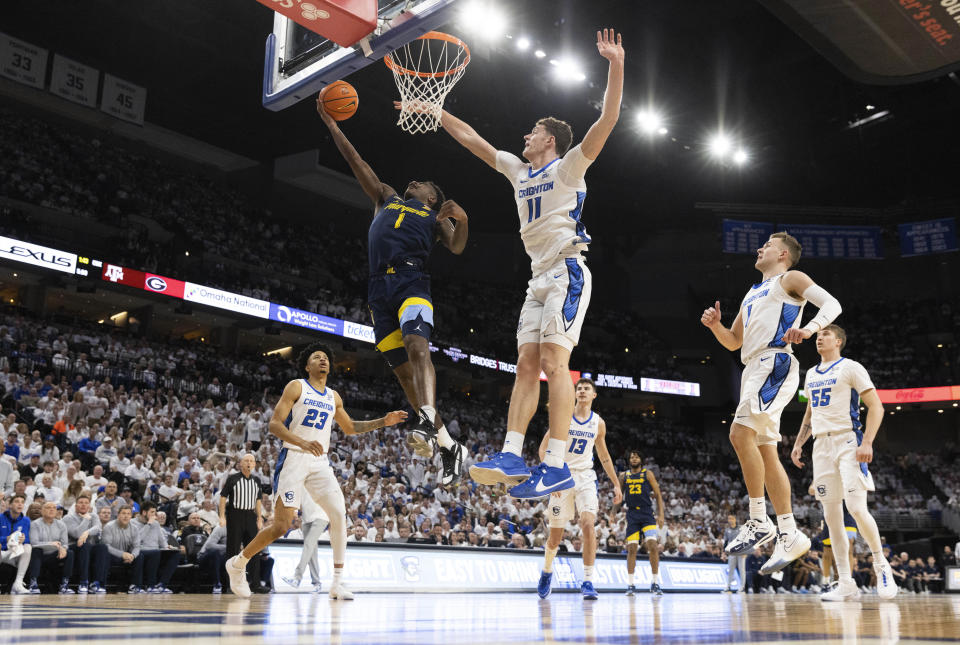 Marquette's Kam Jones (1) shoots against Creighton's Ryan Kalkbrenner (11) during the first half of an NCAA college basketball game Saturday, March 2, 2024, in Omaha, Neb. (AP Photo/Rebecca S. Gratz)