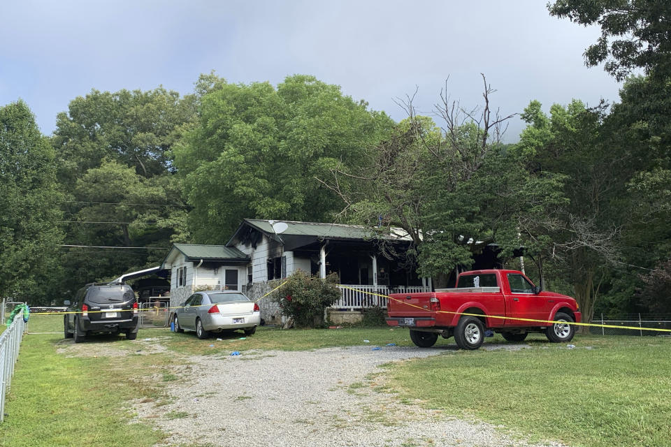 FILE - Police tape blocks off a home in Sequatchie, Tenn., Friday, June 16, 2023. A 48-year-old man is thought to be responsible for killing himself and five others — including three children and his estranged wife — in the home where police responded to a shooting and arrived to find the residence ablaze, authorities said. A seventh person suffered gunshot wounds and was found alive at the home after firefighters extinguished the flames. (Ellen Gerst/Chattanooga Times Free Press via AP, File)