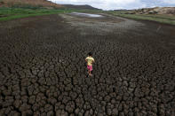 <p>Natan Cabral, 5, stands on the cracked bed of the Boqueirao Reservoir in the Metropolitan Region of Campina Grande, Paraiba state, Brazil, Feb. 13, 2017. (Photo: Ueslei Marcelino/Reuters) </p>