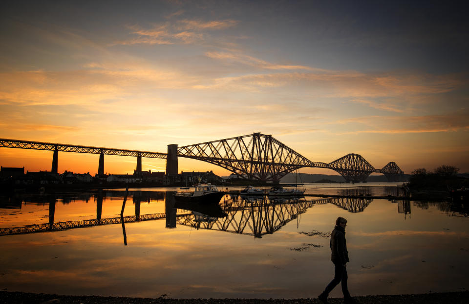 The sun rises behind the Forth Bridge at North Queensferry in Fife. Source: PA