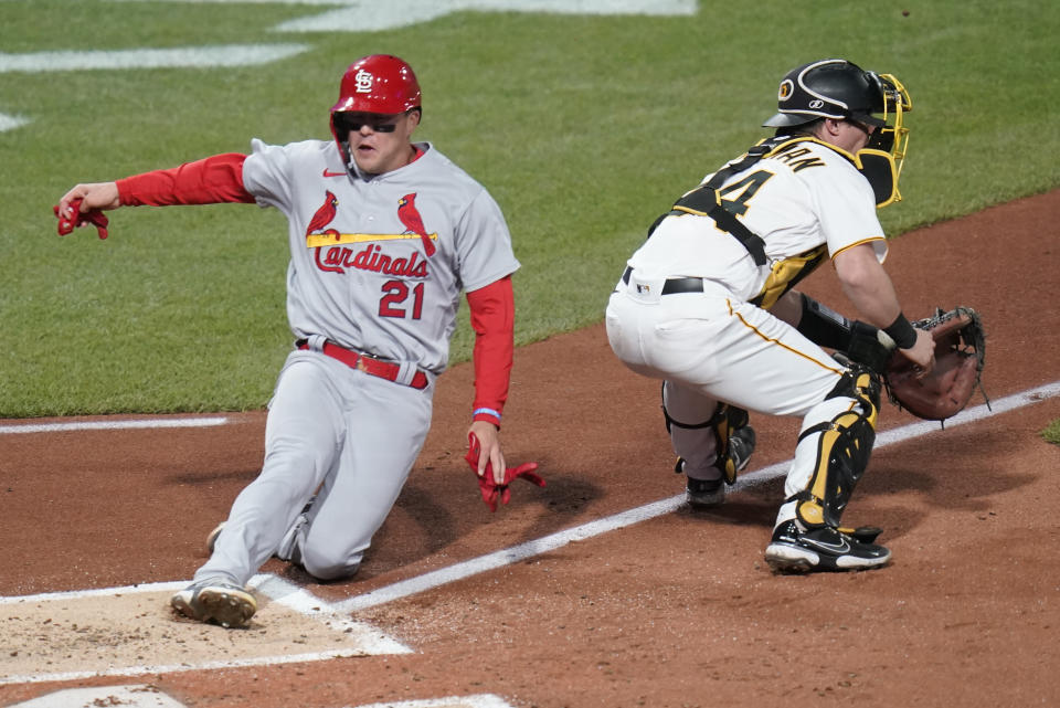 St. Louis Cardinals' Lars Nootbaar (21) scores next to Pittsburgh Pirates catcher Tyler Heineman on a two-run single by Albert Pujols during the third inning of a baseball game Tuesday, Oct. 4, 2022, in Pittsburgh. (AP Photo/Keith Srakocic)