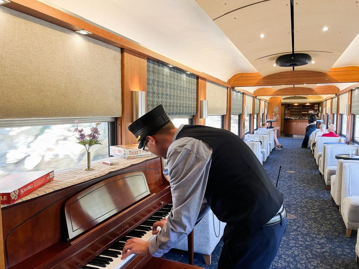 Zach Lucas plays the piano on the first-class train car.