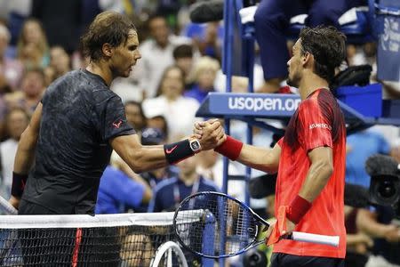 Sep 4, 2015; New York, NY, USA; Fabio Fognini of Italy (R) shakes hands with Rafael Nadal of Spain (L) on day five of the 2015 U.S. Open tennis tournament at USTA Billie Jean King National Tennis Center. Fognini won 3-6, 4-6, 6-4, 6-3, 6-4. Mandatory Credit: Geoff Burke-USA TODAY Sports