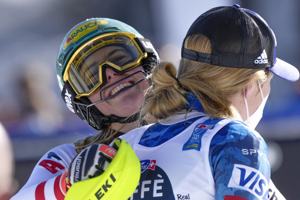 Austria's Katharina Liensberger, face to camera, winner of the women's slalom, celebrates with third placed United States' Mikaela Shiffrin, at the alpine ski World Championships in Cortina d'Ampezzo, Italy, Saturday, Feb. 20, 2021. (AP Photo/Giovanni Auletta)