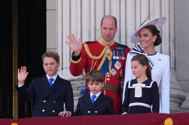 Prince George waves from the Palace balcony alongside Prince Louis, Princess Charlotte and the Prince and Princess of Wales