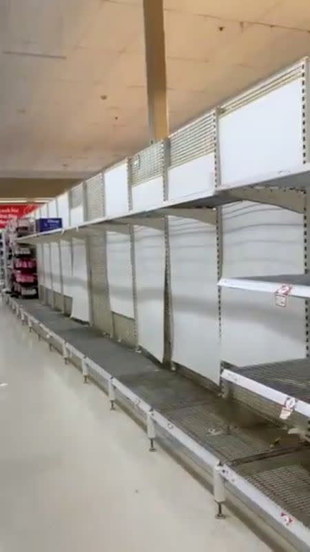 Empty shelves are seen at a Coles supermarket as basic goods are sold out following reports of the coronavirus in Sydney