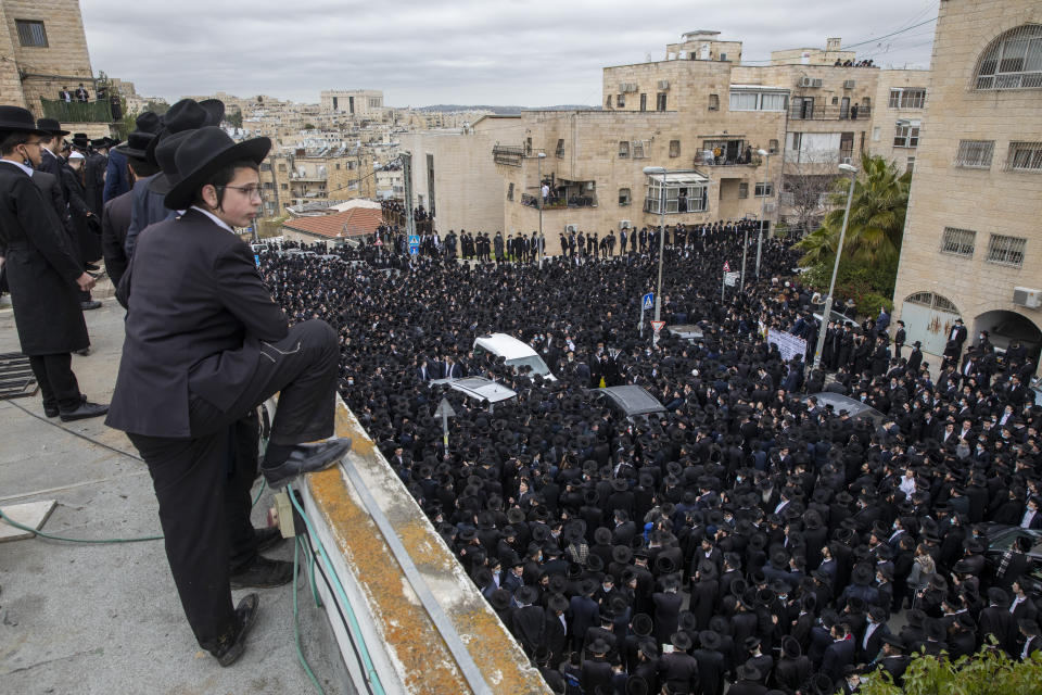 Thousands of ultra-Orthodox Jews participate in funeral for prominent rabbi Meshulam Soloveitchik, in Jerusalem, Sunday, Jan. 31, 2021. The mass ceremony took place despite the country's health regulations banning large public gatherings, during a nationwide lockdown to curb the spread of the coronavirus. (AP Photo/Ariel Schalit)