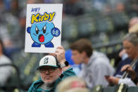 A fan holds a sign for Seattle Mariners starting pitcher George Kirby before a baseball game between the Mariners and the Kansas City Royals, Monday, May 13, 2024, in Seattle. (AP Photo/Lindsey Wasson)