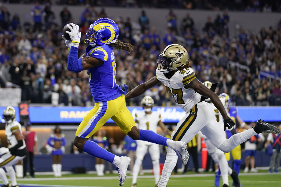 Los Angeles Rams wide receiver Demarcus Robinson (15) makes a touchdown catch past New Orleans Saints cornerback Isaac Yiadom during the first half of an NFL football game Thursday, Dec. 21, 2023, in Inglewood, Calif. (AP Photo/Ashley Landis)