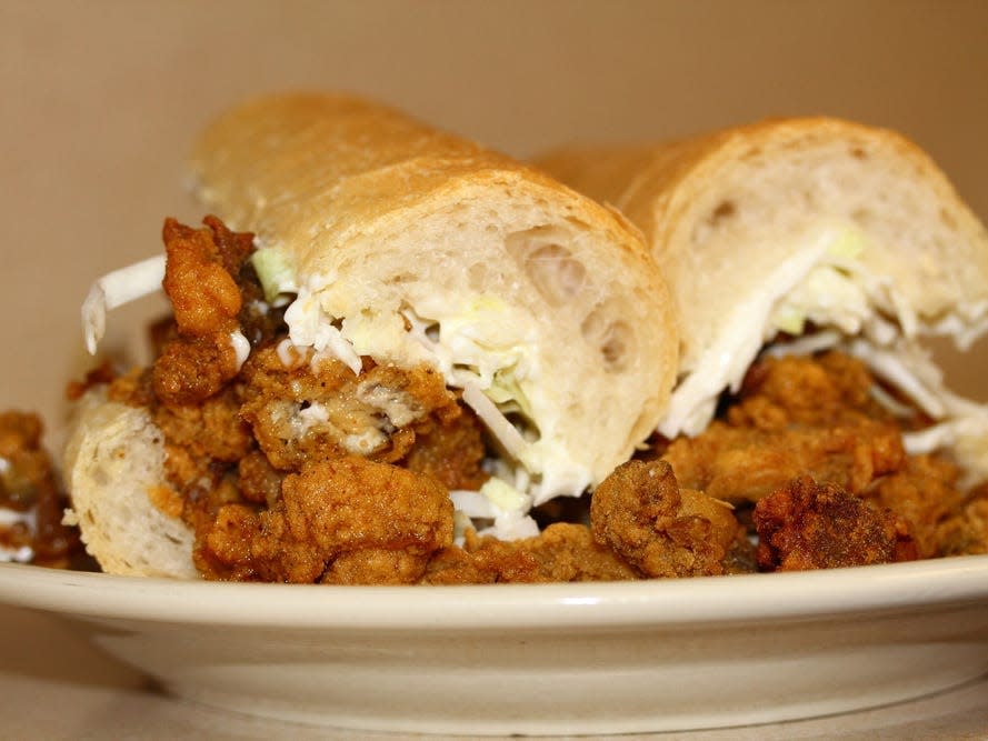 po boy sandwich with fried shrimp on a plate