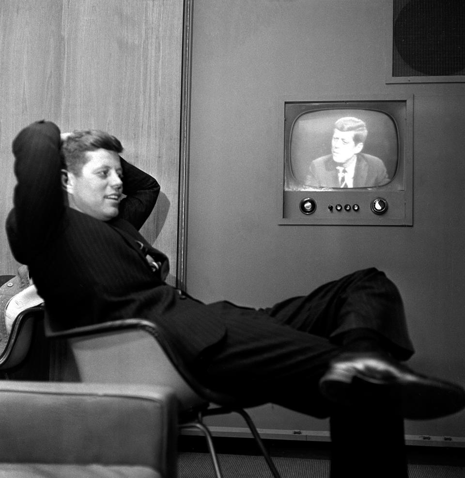 FILE - In this April 3, 1960 file photo, Sen. John F. Kennedy, Democratic presidential nominee, sits next to a playback of his televised appearance in Milwaukee, Wis. for the Wisconsin presidential primary two days later. (AP Photo)