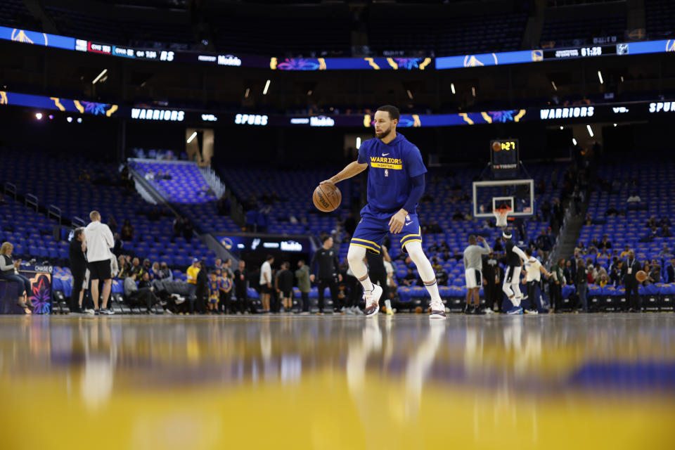 Golden State Warriors guard Stephen Curry warms up before an NBA basketball against the San Antonio Spurs in San Francisco, Friday, March 31, 2023. (AP Photo/Jed Jacobsohn)