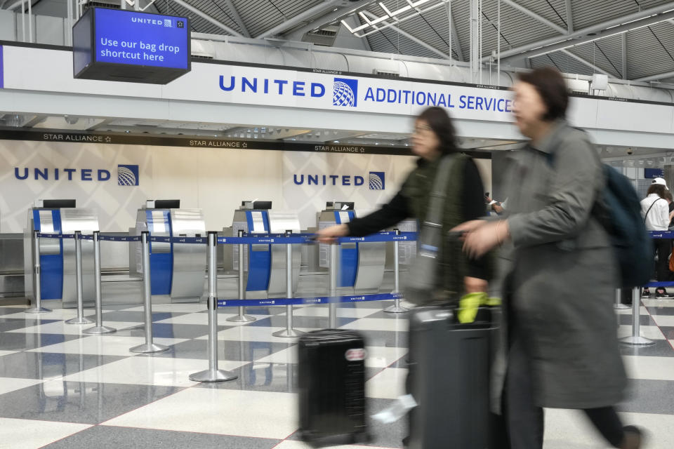 FILE - United Airlines passengers head to a security checkpoint at O'Hare International Airport, Friday, May 12, 2023, in Chicago. Consumers will pay more for that airline flight or for a room in a hotel during peak vacation times. But a big shopper backlash to media reports this past week that fast-food chain Wendy’s had plans to increase prices during the busiest time at its restaurants clearly showed that consumers don’t want basic food items like hamburgers and shakes going up and down. (AP Photo/Charles Rex Arbogast, File)