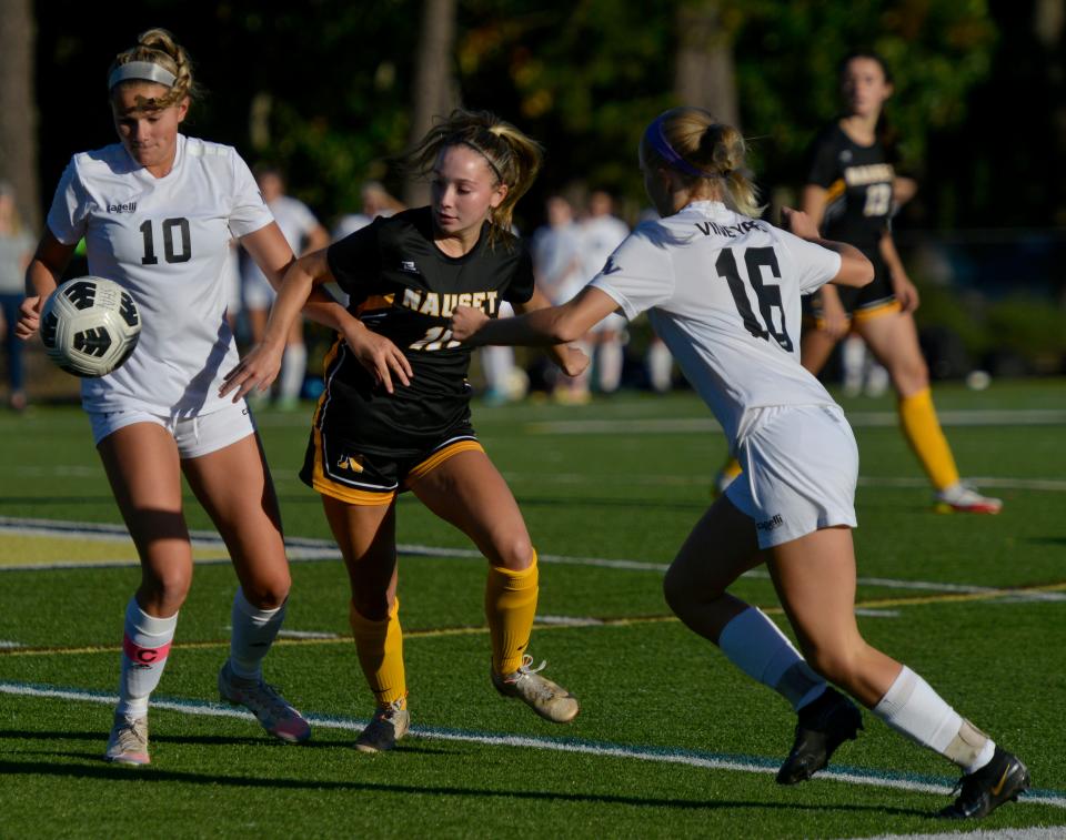 NORTH EASTHAM -- 10/06/22 -- Nauset's Tess Williams, center, tries to block a play by Martha's Vineyard's Josie Welch, left. 
Nauset Regional High School hosted Martha's Vineyard Regional High School in girls soccer action Thursday afternoon.