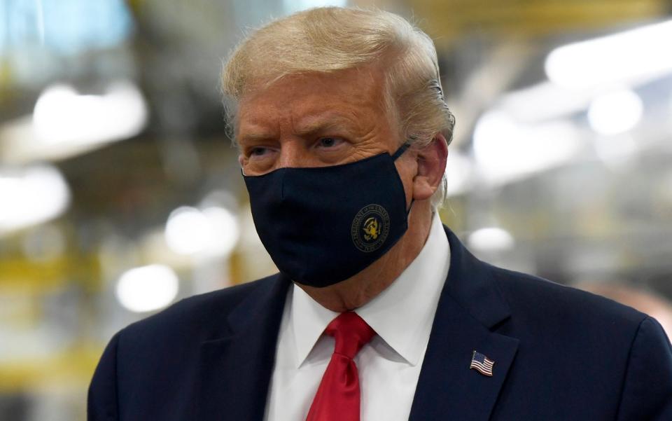 President Donald Trump wears a mask as he tours the Whirlpool Corporation facility in Clyde, Ohio, on August 6 - AP Photo/Susan Walsh