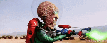 an alien from "Mars Attacks!" shoots a green laser