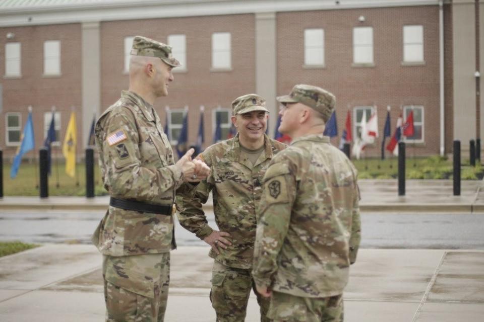 U.S. Army Counterintelligence Command Sgt. Maj. Craig Hood, center, talks with Brig. Gen. Rhett R. Cox, left, the commanding general of Army Counterintelligence Command, and Command Sgt. Maj. Jesse Crawford, right, at a change of responsibility ceremony at Fort Meade, Maryland, October 5, 2022.