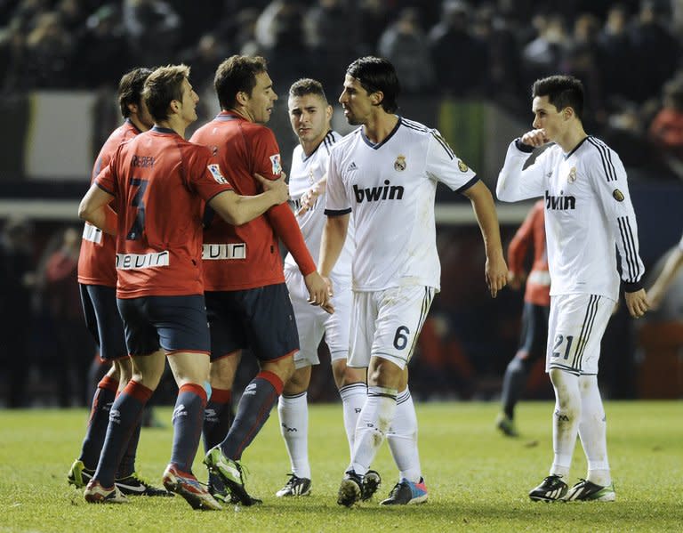 Real Madrid's Sami Khedira (2nd R) argues with Osasuna players during their Spanish La Liga match at the Reyno de Navarra stadium in Pamplona, on January 12, 2013. The match ended in a goalless draw