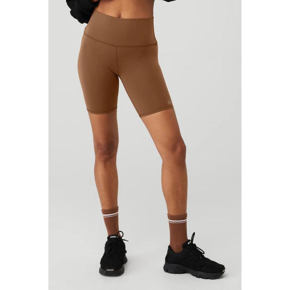 model wearing brown biker shorts with black sneakers