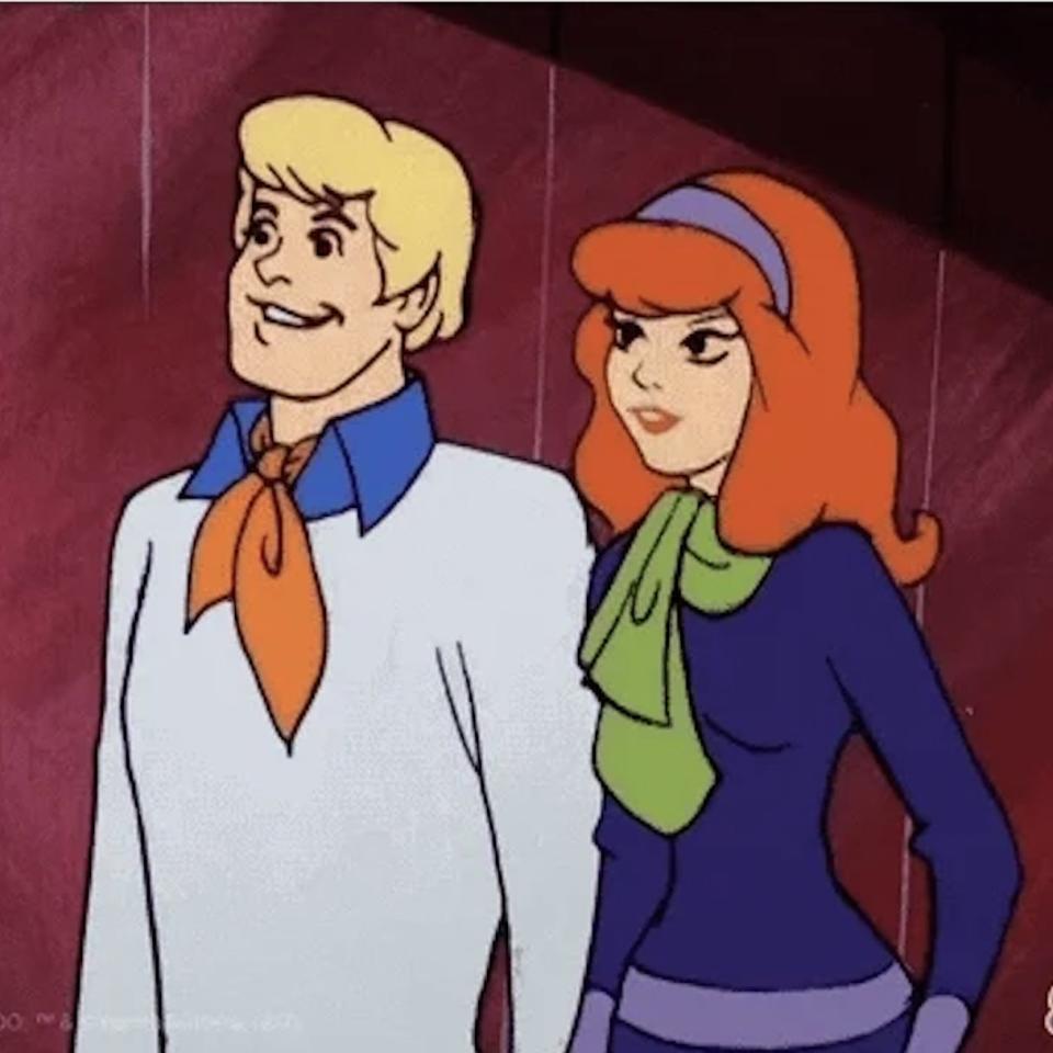 Fred and Daphne from Scooby-Doo, standing side by side, looking ahead with slight smiles