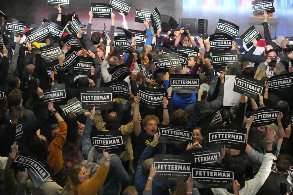 Supporters of Pennsylvania Lt. Gov. John Fetterman, Democratic candidate for U.S. Senate, waves signs during an election night party in Pittsburgh, Wednesday, Nov. 9, 2022. (AP Photo/Gene J. Puskar)