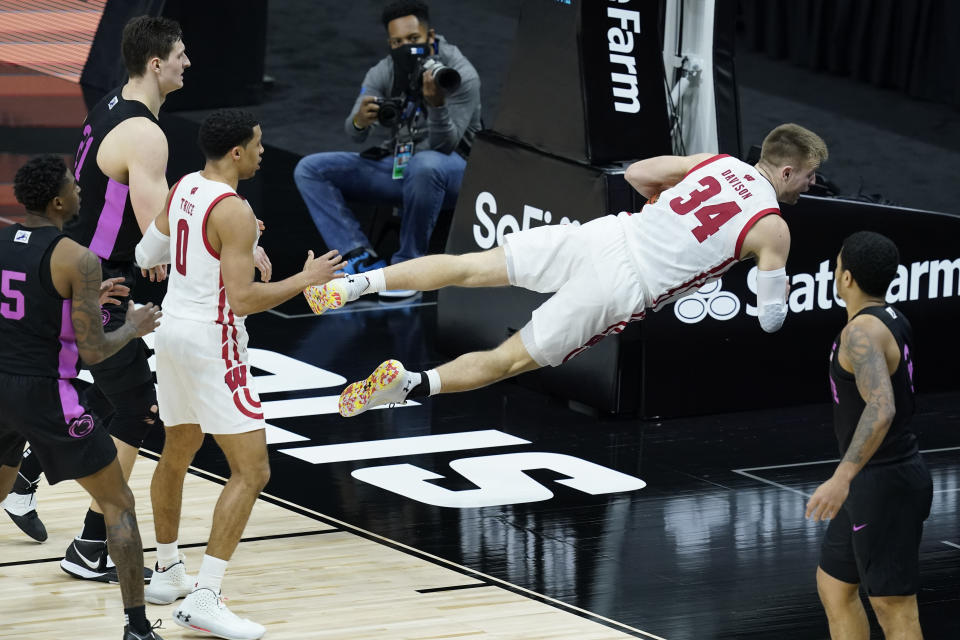 Wisconsin's Brad Davison (34) calls timeout after diving for a loose ball during the second half of an NCAA college basketball game against Penn State at the Big Ten Conference tournament, Thursday, March 11, 2021, in Indianapolis. Wisconsin won 75-74. (AP Photo/Darron Cummings)