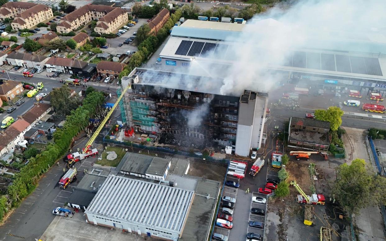 Daylight scene of the smouldering tower block in Dagenham