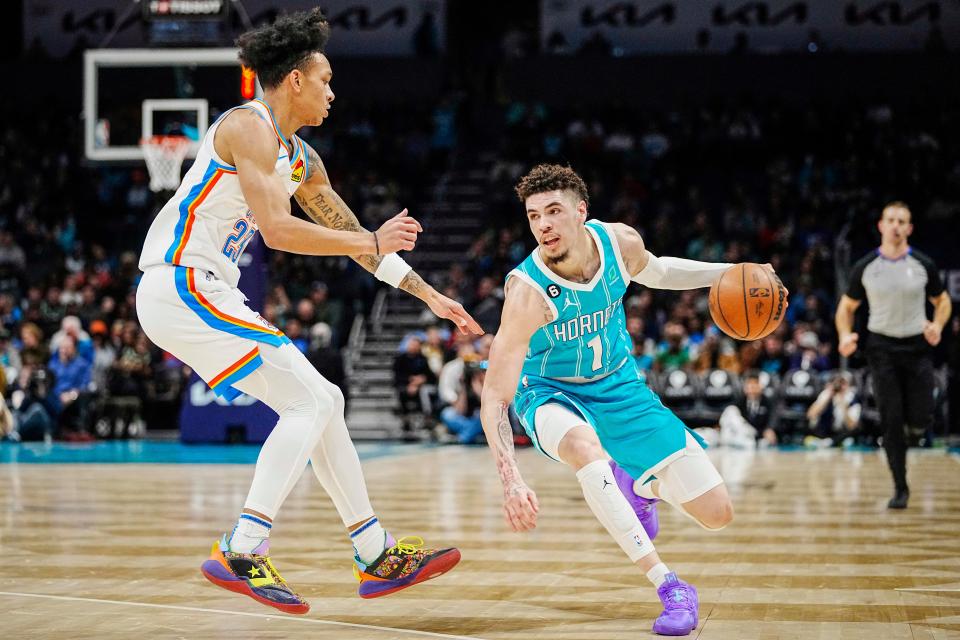 Thunder guard Tre Mann, left, defends against Hornets guard LaMelo Ball, right, during the first half Thursday in Charlotte, N.C.