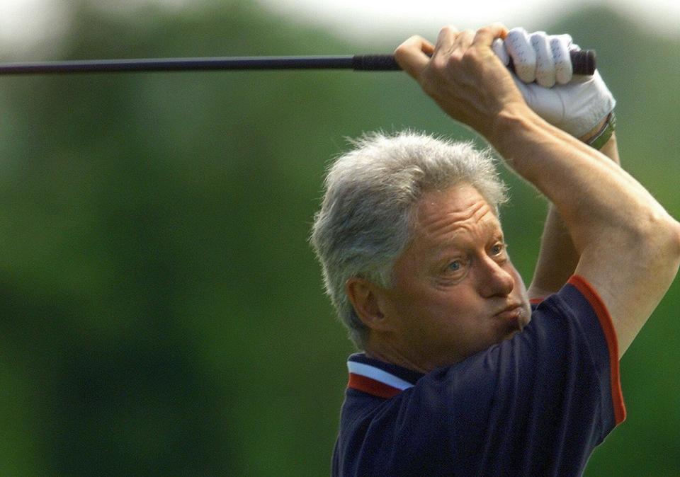 President Clinton watches as his golf ball heads into the trees while on a Martha's Vineyard vacation in August 1999.   (PAUL J. RICHARDS/AFP/Getty Images)