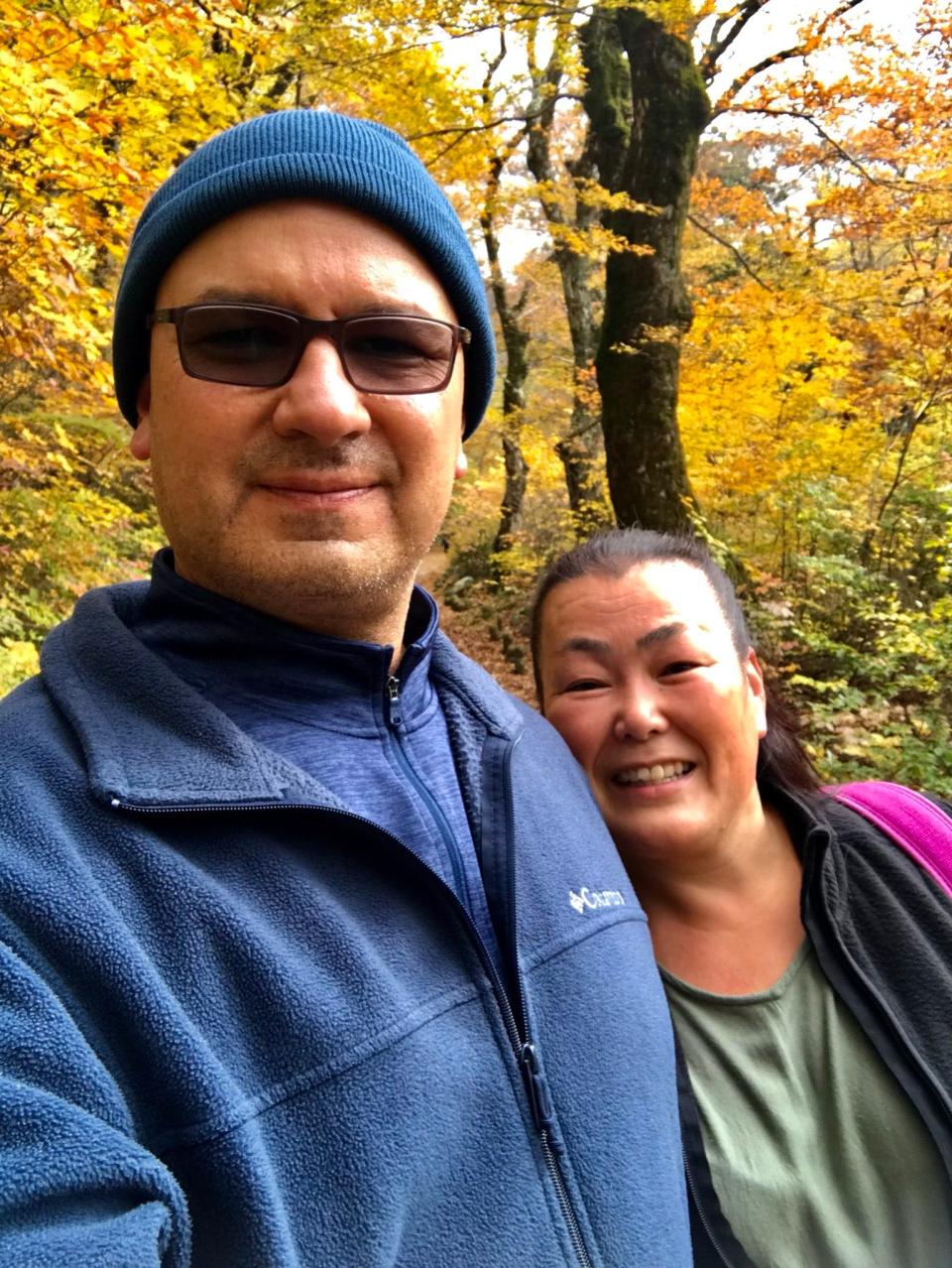 A man and his wife on a hiking trail.