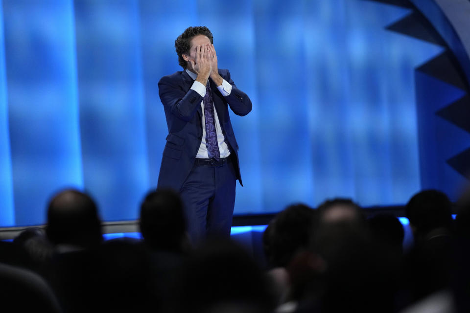 Pastor Joel Osteen wipes away tears as he talks about last week's shooting at Lakewood Church, Sunday, Feb. 18, 2024, in Houston. Osteen welcomed worshippers back to Lakewood Church for the first time since a woman with an AR-style opened fire in between services at his Texas megachurch last Sunday. (AP Photo/David J. Phillip)