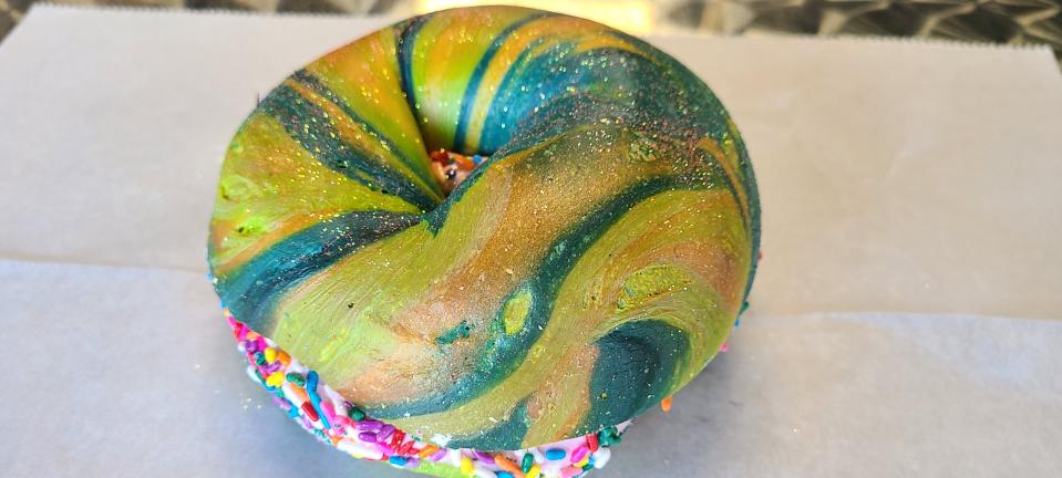 Brooklyn Dough with a Hole's rainbow bagel with edible gold glitter, strawberry cream cheese and sprinkles, $6.