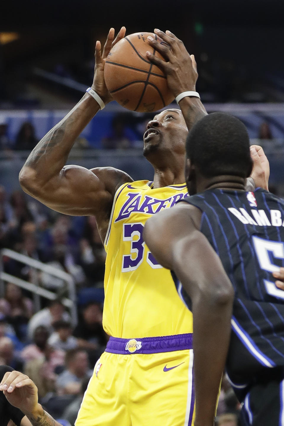 Los Angeles Lakers center Dwight Howard, left, works to get off a shot over Orlando Magic's Mo Bamba, right, during the first half of an NBA basketball game, Wednesday, Dec. 11, 2019, in Orlando, Fla. (AP Photo/John Raoux)