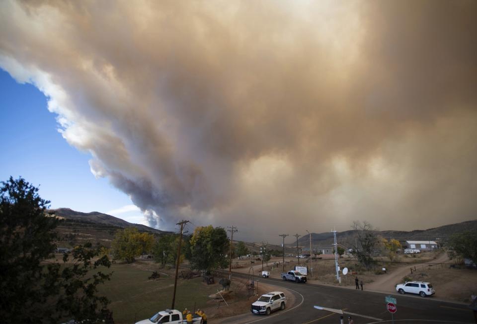 Smoke from the Cameron Peak Fire fills the sky Wednesday, Oct. 14, 2020 in Masonville, Colo. Strong winds fanned two Rocky Mountain wildfires Wednesday, prompting new evacuation orders as one of them spread toward communities that lie outside Rocky Mountain National Park (Bethany Baker/Fort Collins Coloradoan via AP)