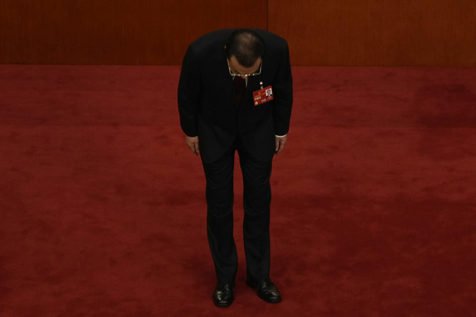 Chinese Premier Li Keqiang bows after delivering his state of the nation address at the opening session of China's National People's Congress (NPC) at the Great Hall of the People in Beijing, Sunday, March 5, 2023. After a decade in Chinese President Xi Jinping's shadow, Li Keqiang is taking his final bow as the country's premier, marking a shift away from the skilled technocrats who have helped steer the world's second-biggest economy in favor of officials known mainly for their unquestioned loyalty to China's most powerful leader in recent history. (AP Photo/Ng Han Guan)