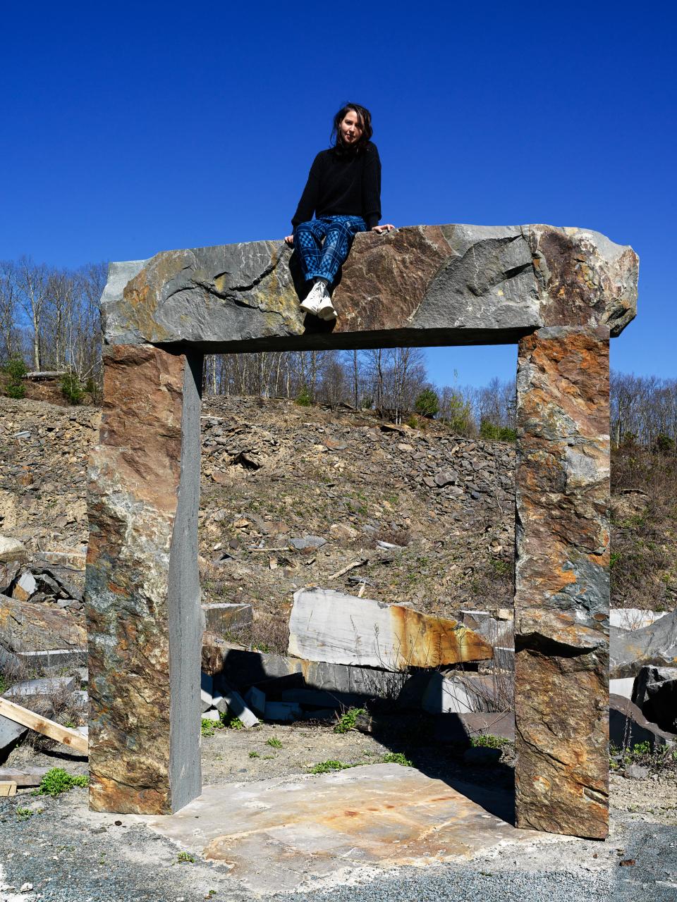 Sam Moyer at a Pennsylvania quarry atop one of three stone portals she is creating for her Public Art Fund project.